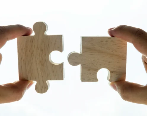 Wooden puzzle pieces coming together